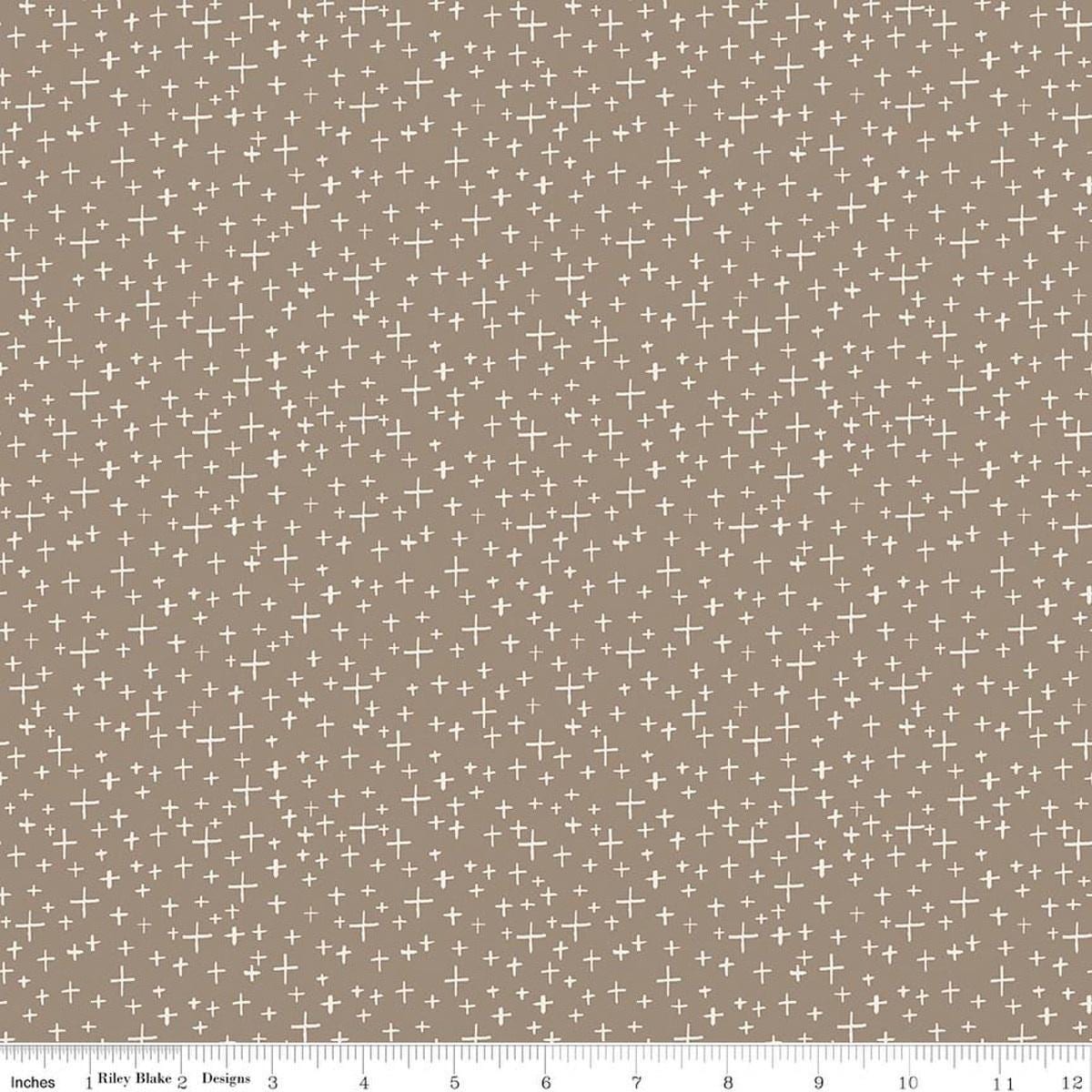 Image of Leo & Savannah Criss Cross Taupe quilting cotton fabric by Deena Rutter for Riley Blake Designs. Features crosses on a brown background. Cute Little Fabric Shop.