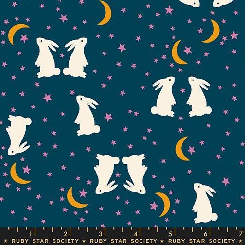 Image of Mystic Fable Fable Bunnies Galaxy quilting cotton fabric by Alexia Abegg of Ruby Star Society for Moda Fabrics. Features bunnies and stars on a blue background. Cute Little Fabric Shop.