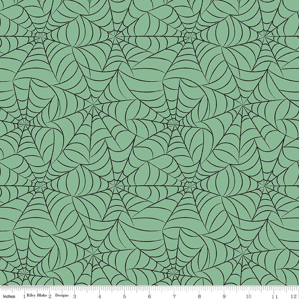 Image of Frank and Friends Webs Green quilting cotton fabric by My Mind's Eye for Riley Blake Designs. Features spider webbing on a green background. Cute Little Fabric Shop.