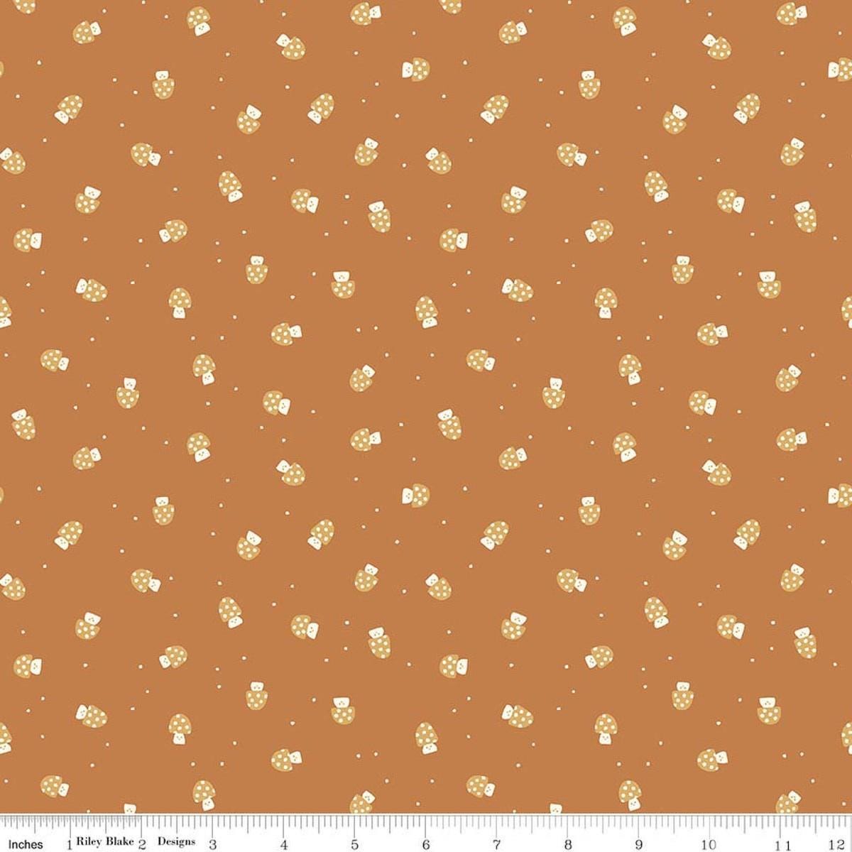 Image of Faraway Kingdom Mushroom Cheer Earth quilting cotton fabric by Natàlia Juan Abelló for Riley Blake Designs. Features mushrooms on a brown background. Cute Little Fabric Shop.