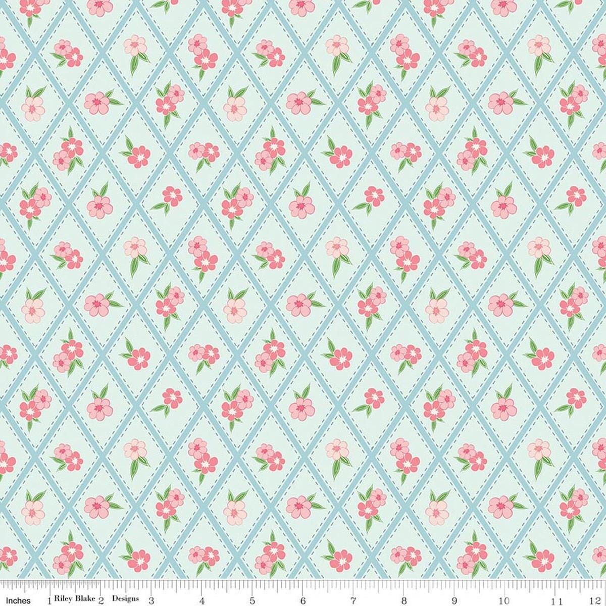 Image of Correspondence Stitched Flowers Washed Denim quilting cotton fabric by Beverly McCullough for Riley Blake Designs. Features flowers on a blue background. Cute Little Fabric Shop.