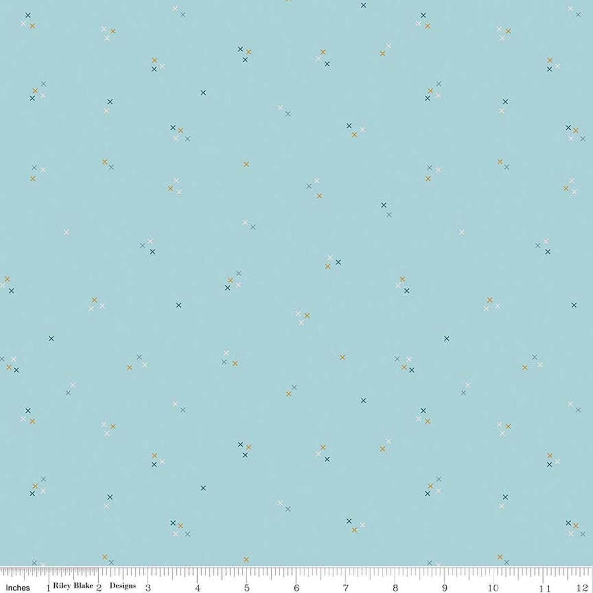 Image of Correspondence Stitching Aqua quilting cotton fabric by Beverly McCullough for Riley Blake Designs. Features tiny xs on a blue background. Cute Little Fabric Shop.