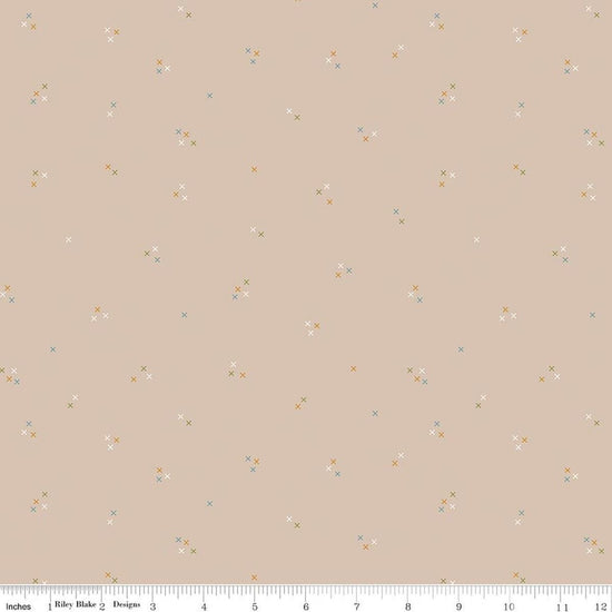 Image of Correspondence Stitching Wheat quilting cotton fabric by Beverly McCullough for Riley Blake Designs. Features tiny xs on a brown background. Cute Little Fabric Shop.