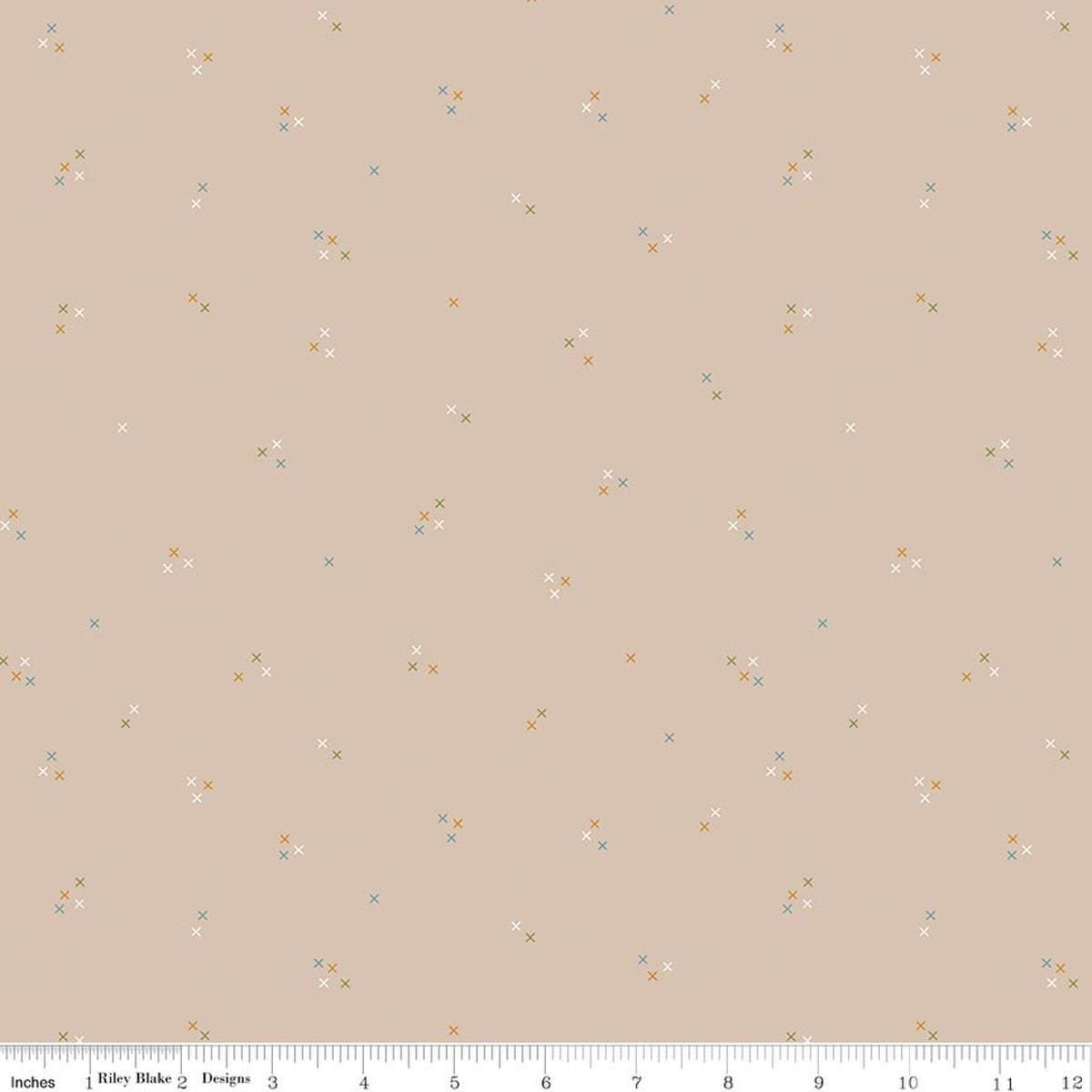Image of Correspondence Stitching Wheat quilting cotton fabric by Beverly McCullough for Riley Blake Designs. Features tiny xs on a brown background. Cute Little Fabric Shop.