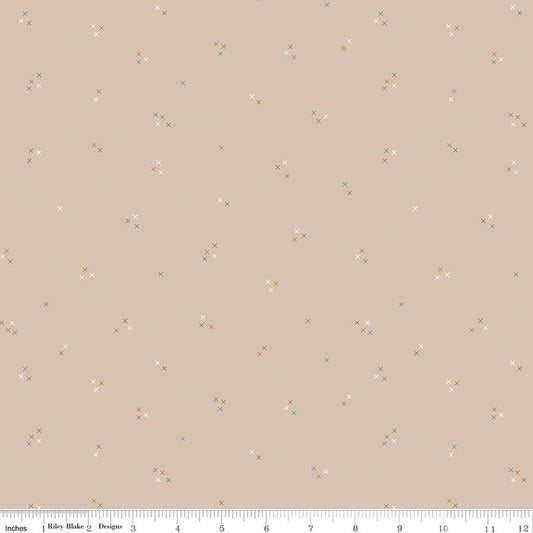 Image of Correspondence Stitching Wheat quilting cotton fabric by Beverly McCullough for Riley Blake Designs. Features tiny xs on a brown background. Cute Little Fabric Shop.