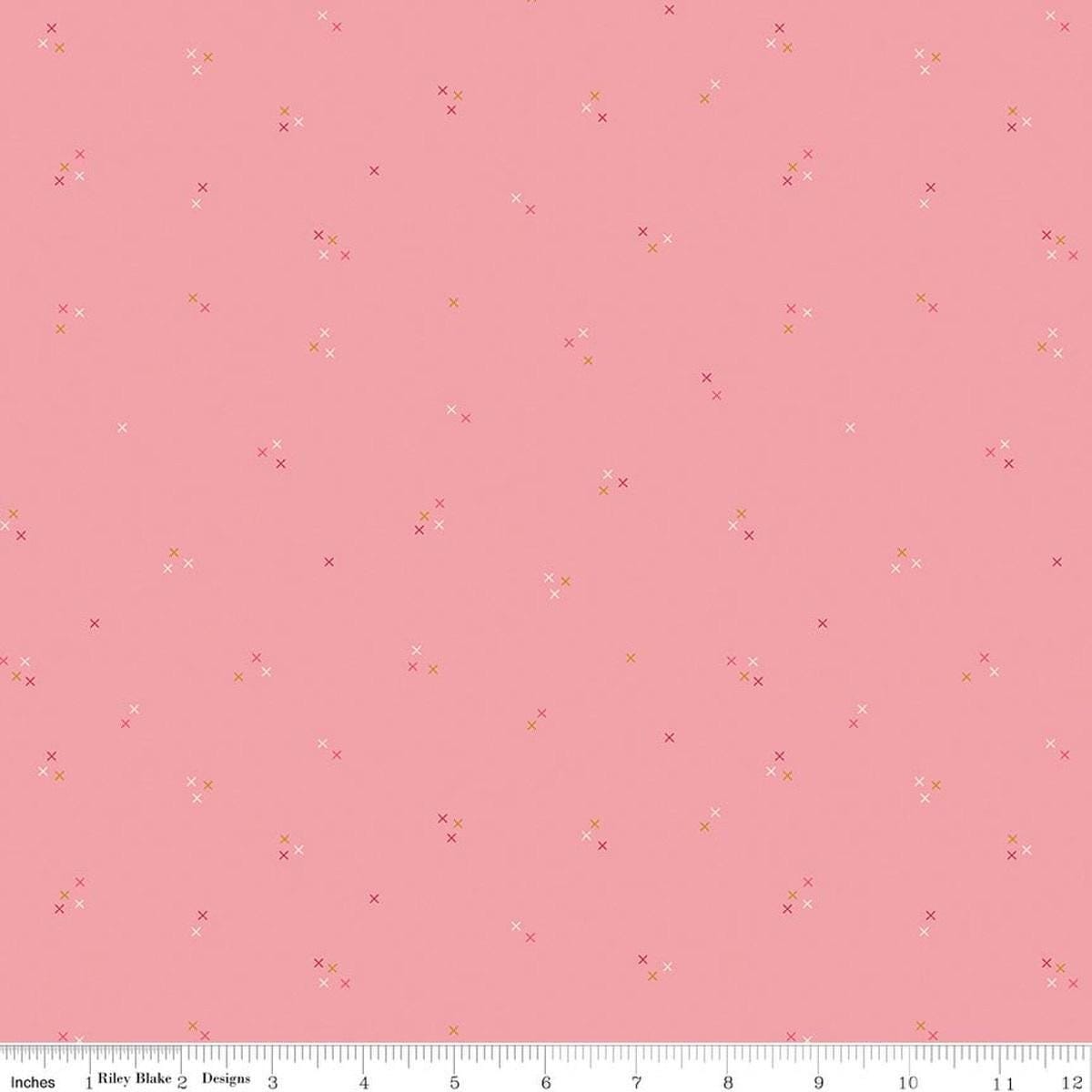 Image of Correspondence Stitching Peony quilting cotton fabric by Beverly McCullough for Riley Blake Designs. Features tiny xs on a pink background. Cute Little Fabric Shop.