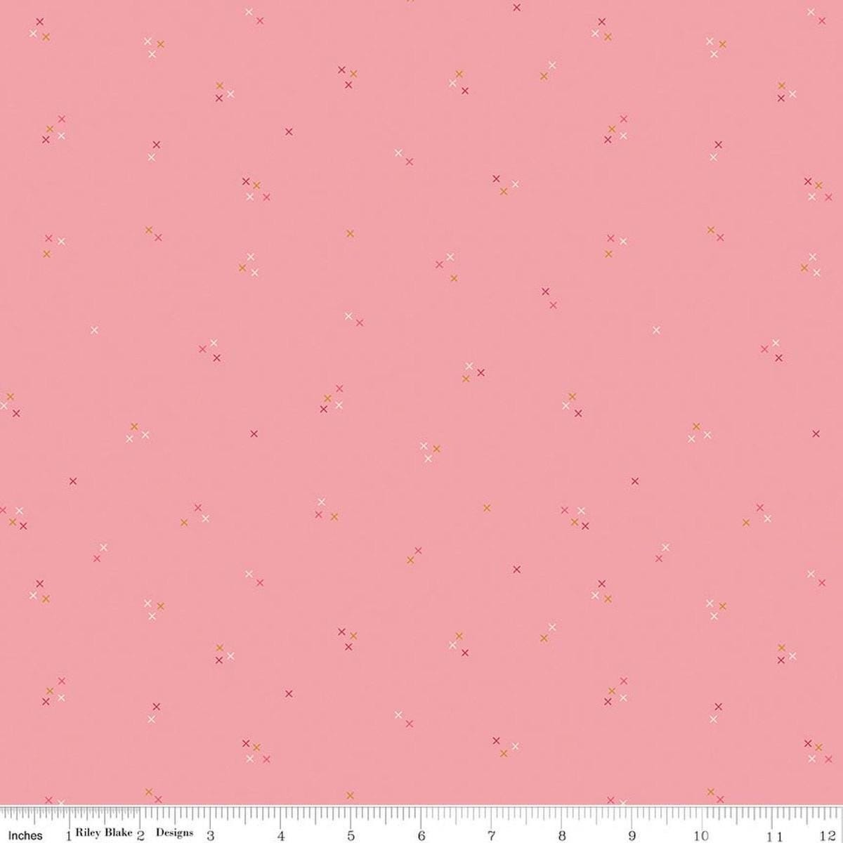 Image of Correspondence Stitching Peony quilting cotton fabric by Beverly McCullough for Riley Blake Designs. Features tiny xs on a pink background. Cute Little Fabric Shop.