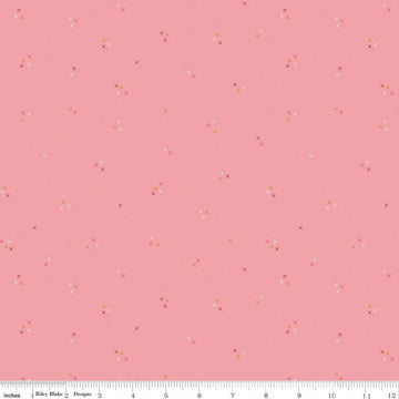 Image of Correspondence Stitching Peony quilting cotton fabric by Beverly McCullough for Riley Blake Designs. Features tiny xs on a pink background. Cute Little Fabric Shop.