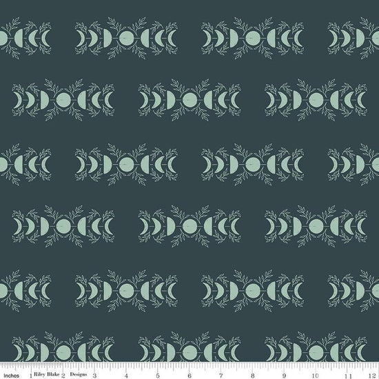 Image of The Apothecary Celestial Teal quilting cotton fabric by Amber Elliot for Riley Blake Designs. Features moons on a blue background. Cute Little Fabric Shop.