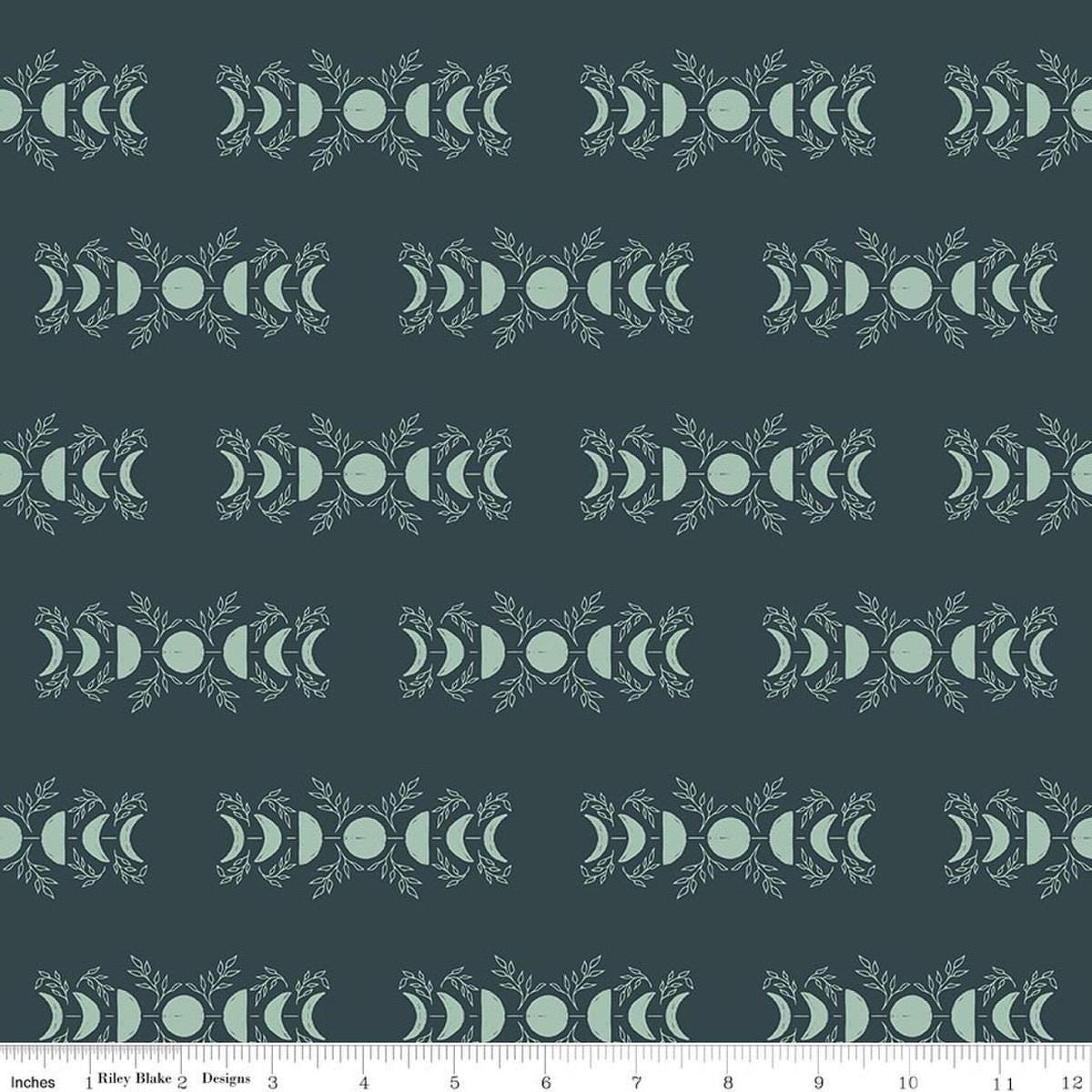 Image of The Apothecary Celestial Teal quilting cotton fabric by Amber Elliot for Riley Blake Designs. Features moons on a blue background. Cute Little Fabric Shop.