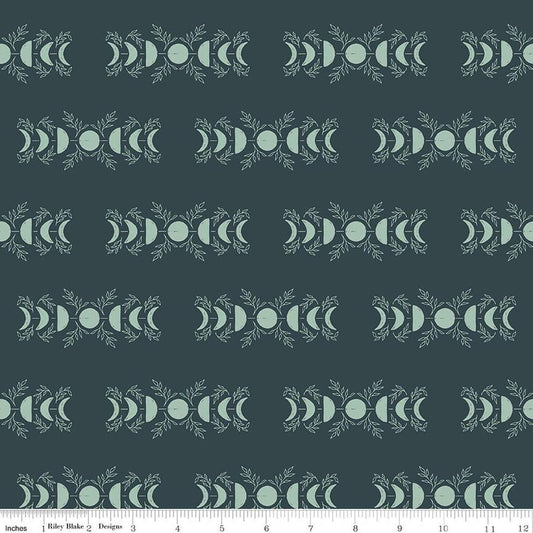 Image of The Apothecary Celestial Teal quilting cotton fabric by Amber Elliot for Riley Blake Designs. Features moons on a blue background. Cute Little Fabric Shop.