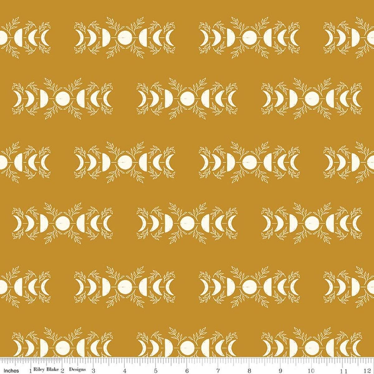 Image of The Apothecary Celestial Gold quilting cotton fabric by Amber Elliot for Riley Blake Designs. Features moons on a gold background. Cute Little Fabric Shop.