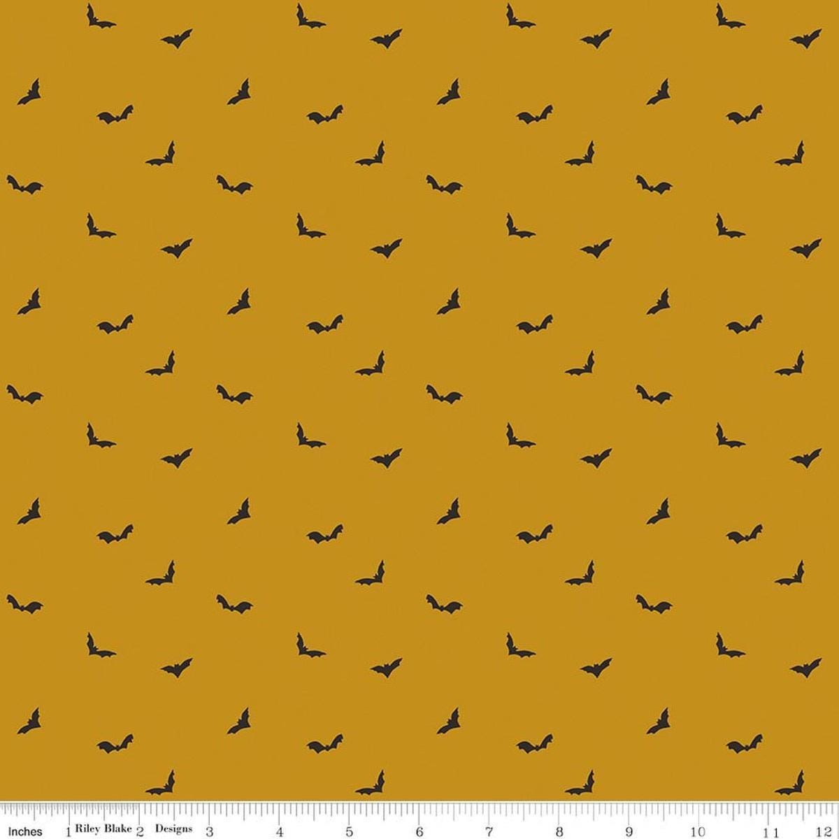 Image of The Apothecary Batwings Gold quilting cotton fabric by Amber Elliot for Riley Blake Designs. Features bats on a yellow background. Cute Little Fabric Shop.