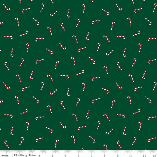 Image of Seasonal Basics Candy Canes Green quilting cotton fabric by Christopher Thompson for Riley Blake Designs. Features candy canes on a green background. Cute Little Fabric Shop.