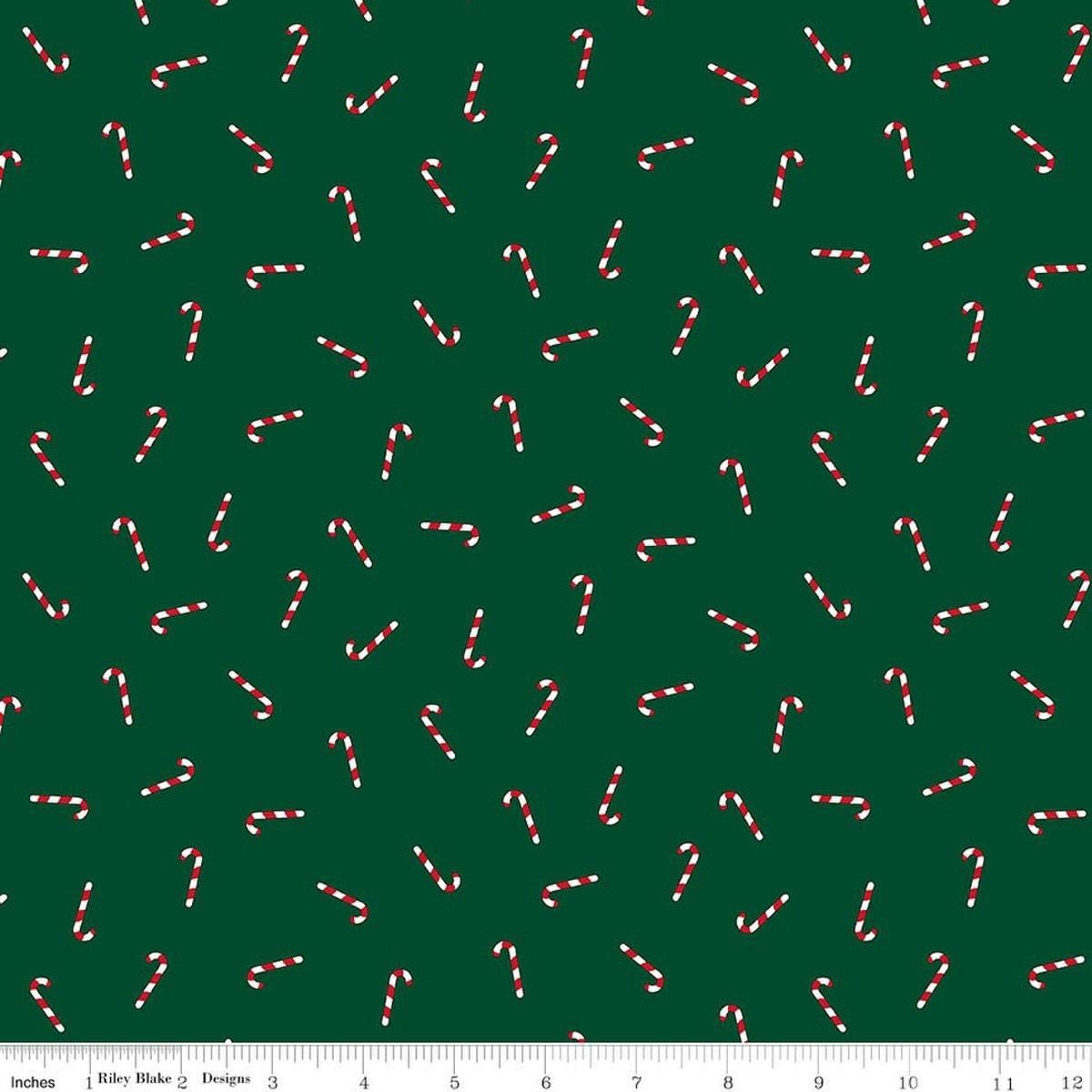 Image of Seasonal Basics Candy Canes Green quilting cotton fabric by Christopher Thompson for Riley Blake Designs. Features candy canes on a green background. Cute Little Fabric Shop.