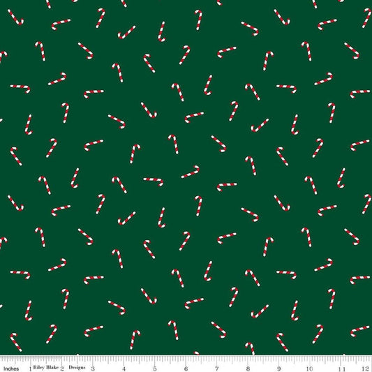 Image of Seasonal Basics Candy Canes Green quilting cotton fabric by Christopher Thompson for Riley Blake Designs. Features candy canes on a green background. Cute Little Fabric Shop.