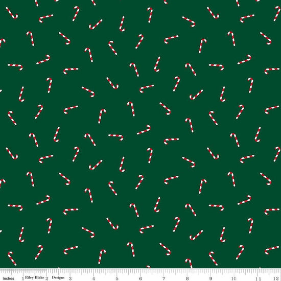 Image of Seasonal Basics Candy Canes Green quilting cotton fabric by Christopher Thompson for Riley Blake Designs. Features candy canes on a green background. Cute Little Fabric Shop.