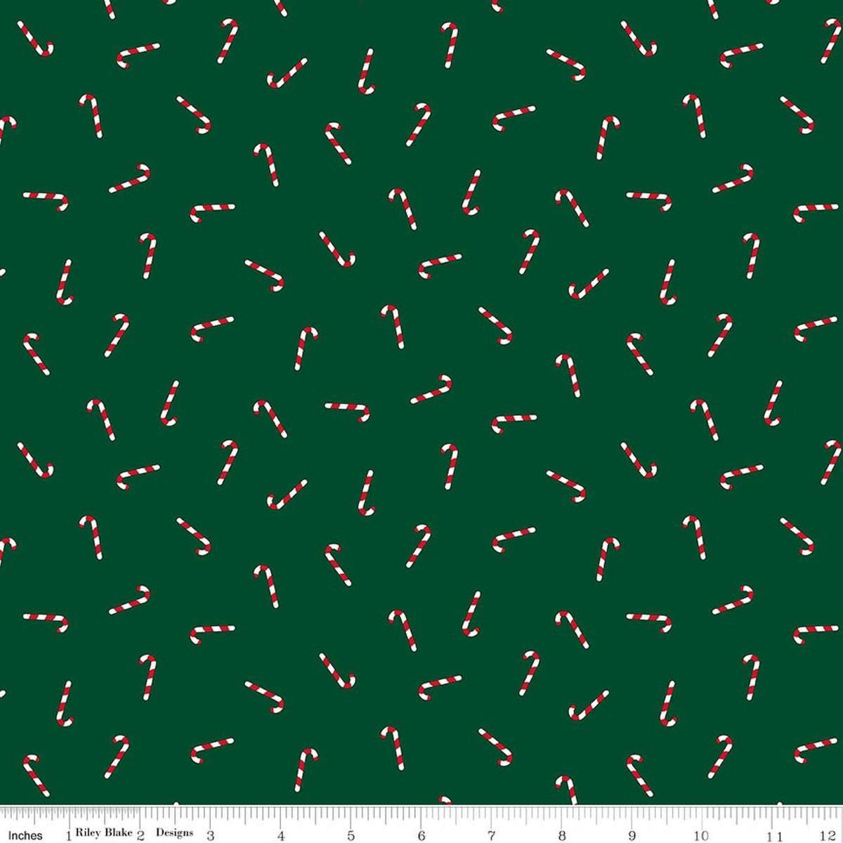 Image of Seasonal Basics Candy Canes Green quilting cotton fabric by Christopher Thompson for Riley Blake Designs. Features candy canes on a green background. Cute Little Fabric Shop.
