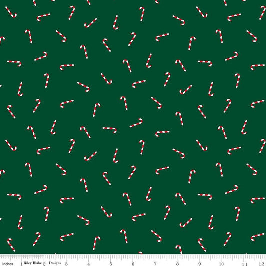 Image of Seasonal Basics Candy Canes Green quilting cotton fabric by Christopher Thompson for Riley Blake Designs. Features candy canes on a green background. Cute Little Fabric Shop.