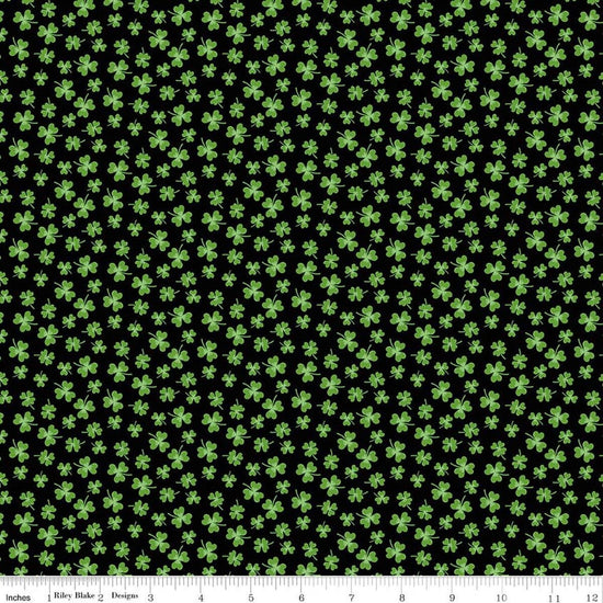Image of Seasonal Basics Shamrocks Black quilting cotton fabric by Christopher Thompson for Riley Blake Designs. Features clovers on a black background. Cute Little Fabric Shop.