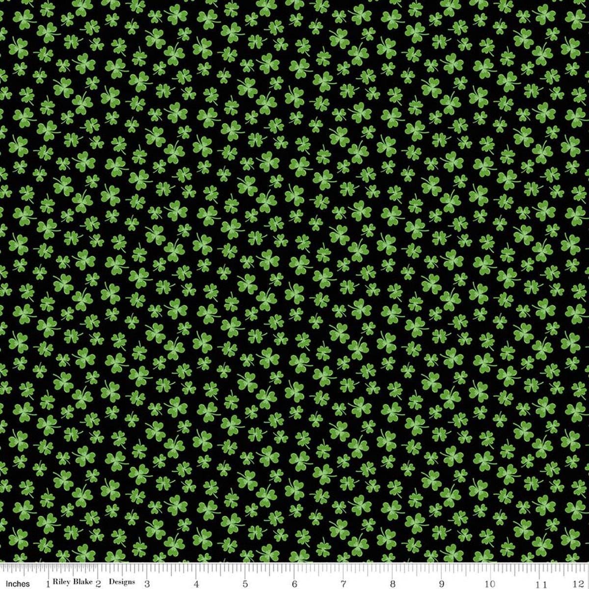 Image of Seasonal Basics Shamrocks Black quilting cotton fabric by Christopher Thompson for Riley Blake Designs. Features clovers on a black background. Cute Little Fabric Shop.