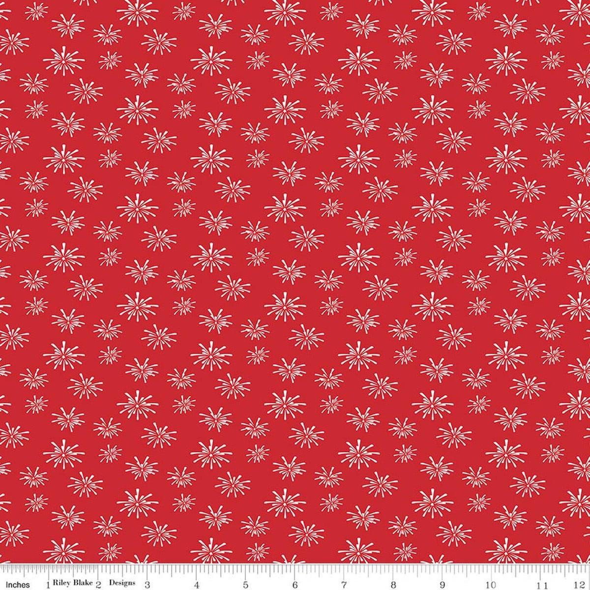 Image of Seasonal Basics Fireworks Red quilting cotton fabric by Christopher Thompson for Riley Blake Designs. Features fireworks on a red background. Cute Little Fabric Shop.