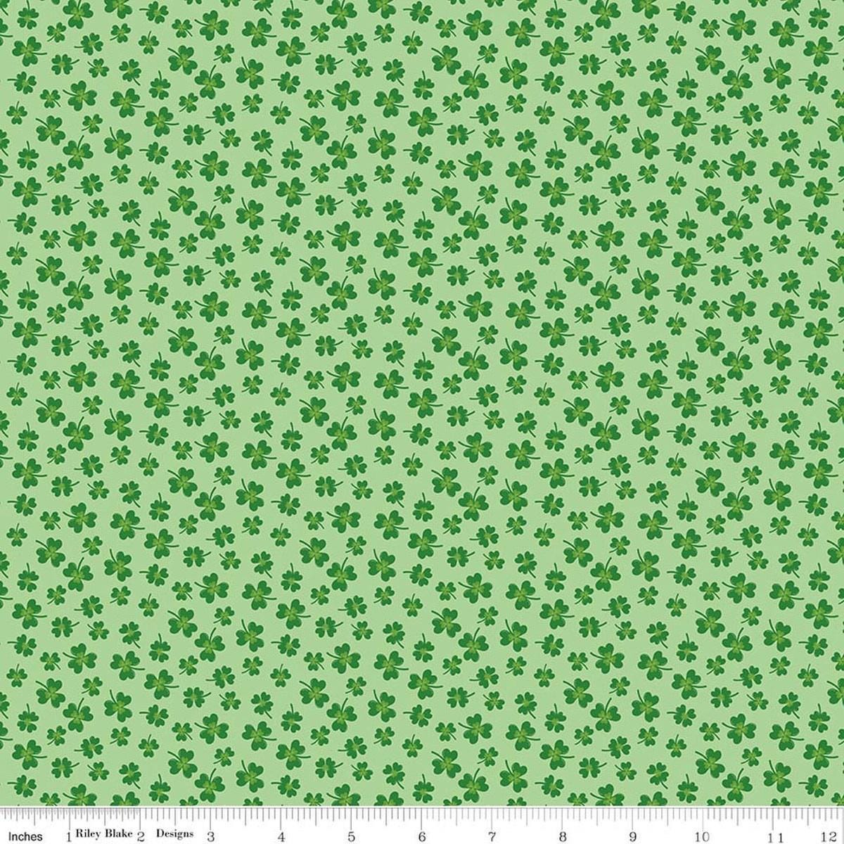 Image of Seasonal Basics Shamrocks Green quilting cotton fabric by Christopher Thompson for Riley Blake Designs. Features clovers on a green background. Cute Little Fabric Shop.