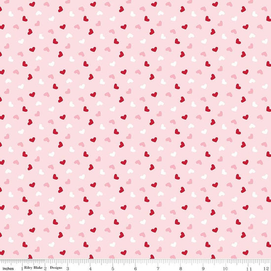 Image of Seasonal Basics Heart Toss Pink quilting cotton fabric by Christopher Thompson for Riley Blake Designs. Features hearts on a pink background. Cute Little Fabric Shop.