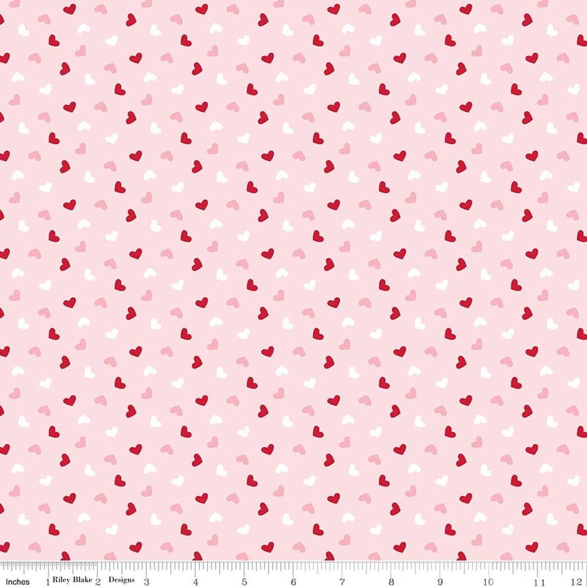 Image of Seasonal Basics Heart Toss Pink quilting cotton fabric by Christopher Thompson for Riley Blake Designs. Features hearts on a pink background. Cute Little Fabric Shop.