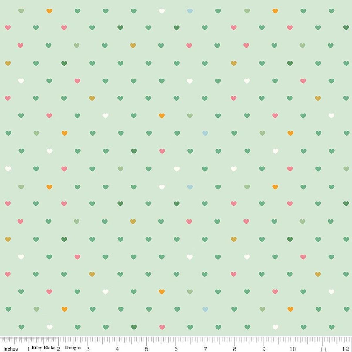 Image of Designer Flannel Meadow Serendipity 2 Hearts Mint flannel cotton fabric by Minki Kim for Riley Blake Designs. Features hearts on a green background. Cute Little Fabric Shop.