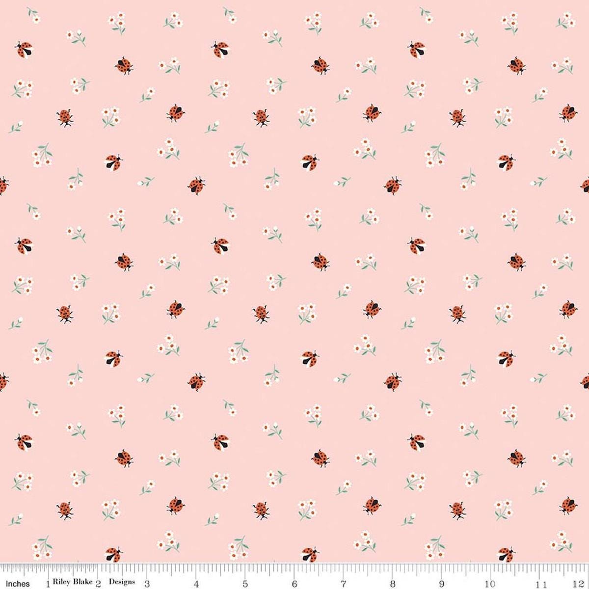 Image of Designer Flannel Meadow Moments Ladybugs Pink flannel cotton fabric by Sandra Nygard-Partheons for Riley Blake Designs. Features ladybugs and flowers on a pink background. Cute Little Fabric Shop.