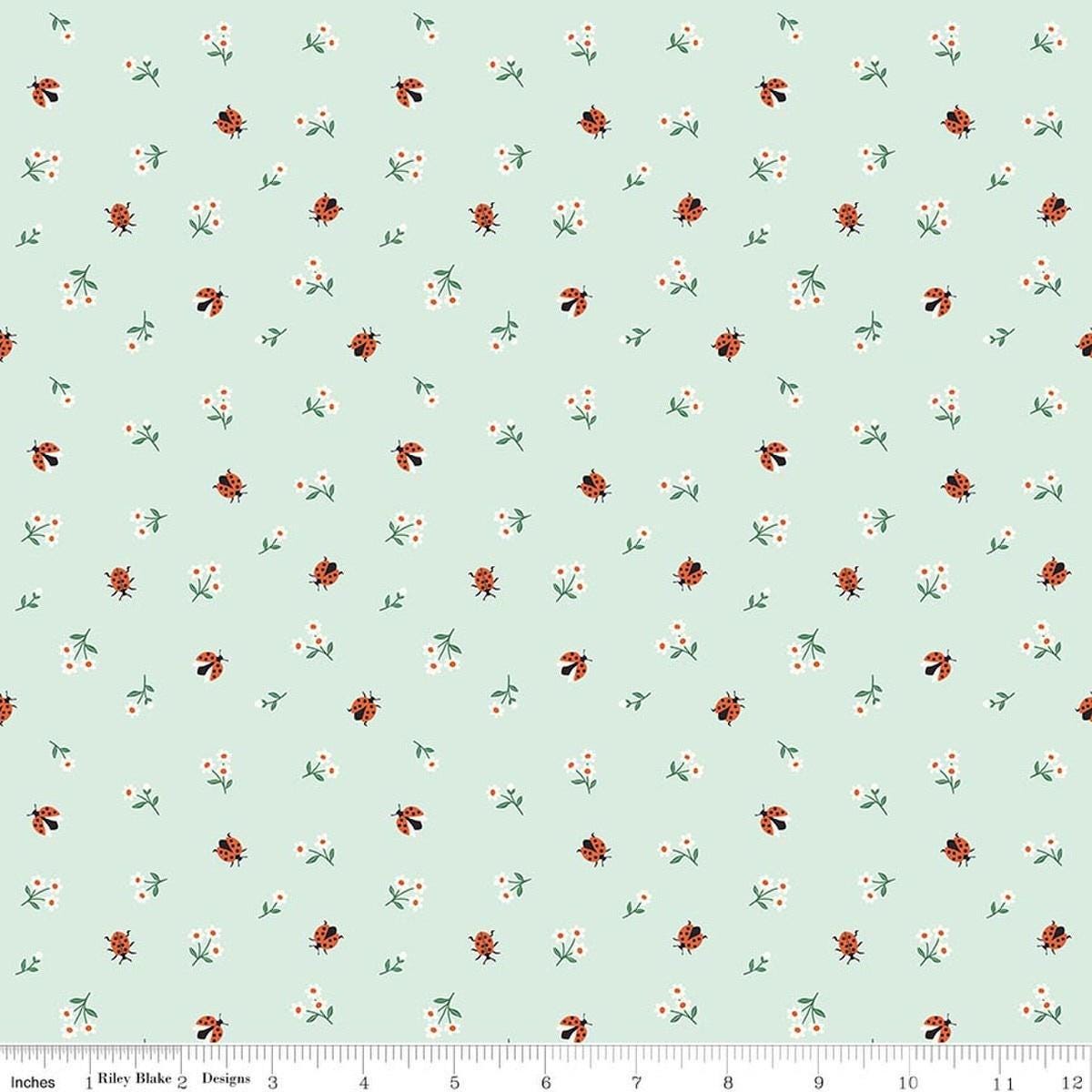 Image of Designer Flannel Meadow Moments Ladybugs Mint flannel cotton fabric by Sandra Nygard-Parthoens for Riley Blake Designs. Features ladybugs and flowers on a green background. Cute Little Fabric Shop.
