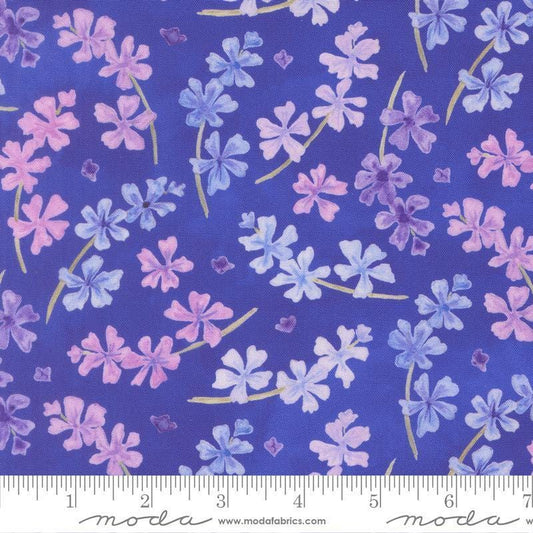 Image of Delphinium Lilacs Agapanthus quilting cotton by Janet Clare for Moda Fabrics. Features flowers on a blue background. Cute Little Fabric Shop.