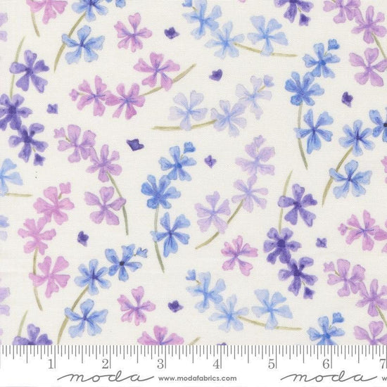Image of Delphinium Lilacs Snowdrop quilting cotton by Janet Clare for Moda Fabrics. Features flowers on a white background. Cute Little Fabric Shop.