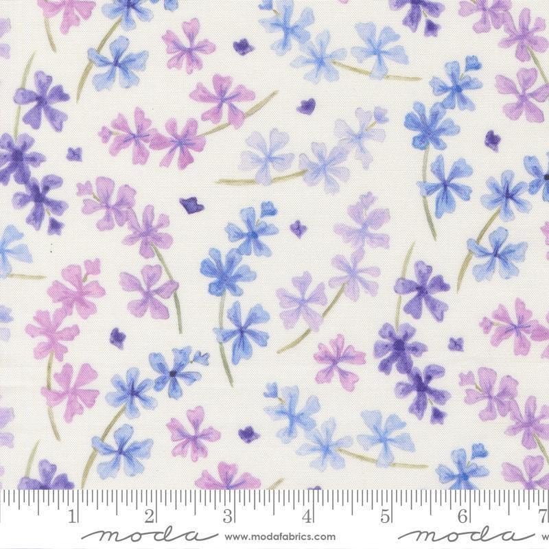 Image of Delphinium Lilacs Snowdrop quilting cotton by Janet Clare for Moda Fabrics. Features flowers on a white background. Cute Little Fabric Shop.
