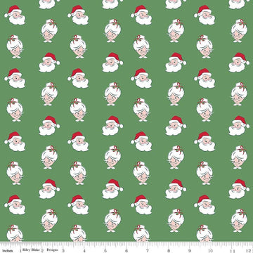 Image of Claus & Co. Santa Heads Green quilting cotton fabric by Melissa Mortenson for Riley Blake Designs. Features santa heads on a green background. Cute Little Fabric Shop.