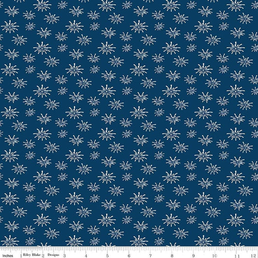 Image of Seasonal Basics Fireworks Denim quilting cotton fabric by Christopher Thompson for Riley Blake Designs. Features fireworks on a blue background. Cute Little Fabric Shop.