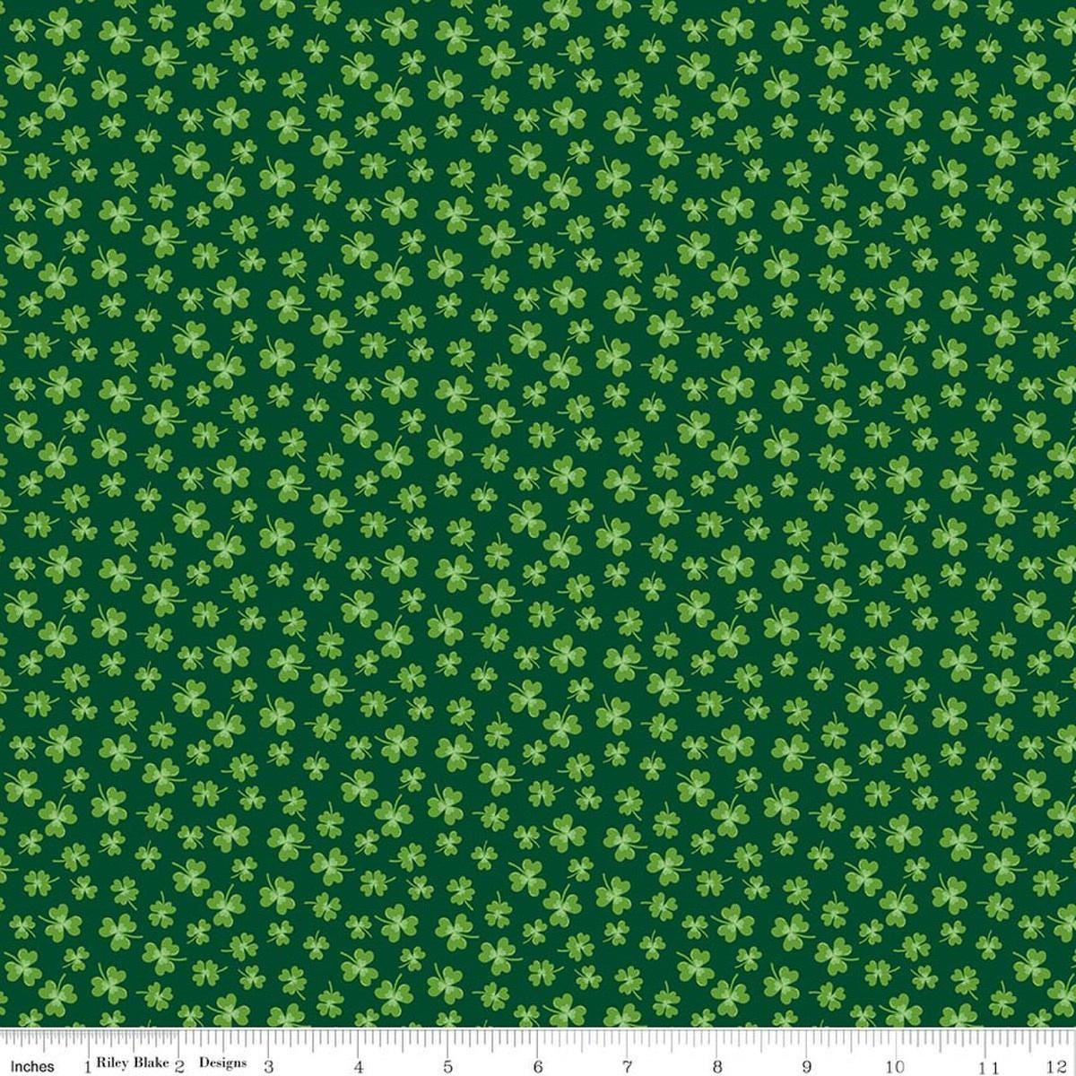 Image of Seasonal Basics Shamrocks Green quilting cotton fabric by Christopher Thompson for Riley Blake Designs. Features clovers on a green background. Cute Little Fabric Shop.