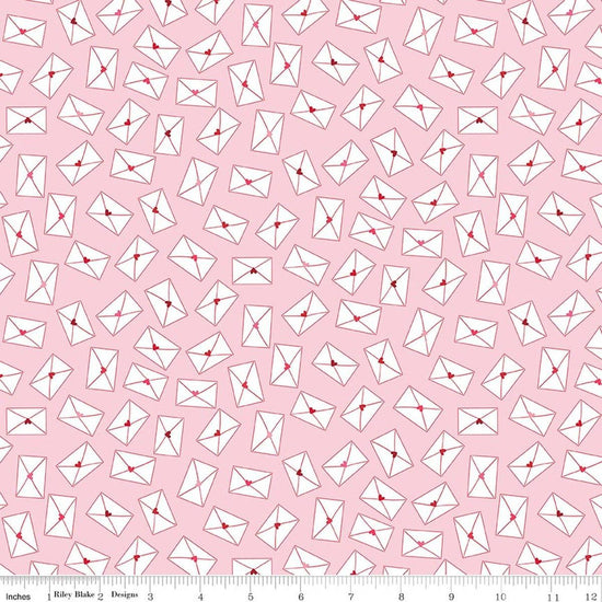 Image of Seasonal Basics Love Notes Pink quilting cotton fabric by Christopher Thompson for Riley Blake Designs. Features envelopes on a pink background. Cute Little Fabric Shop.
