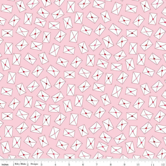 Image of Seasonal Basics Love Notes Pink quilting cotton fabric by Christopher Thompson for Riley Blake Designs. Features envelopes on a pink background. Cute Little Fabric Shop.