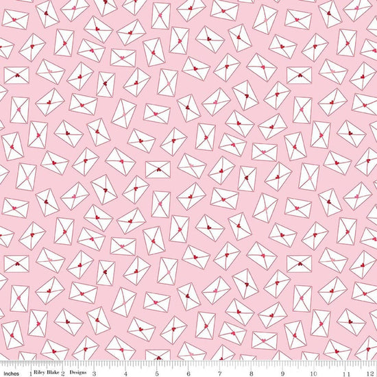 Image of Seasonal Basics Love Notes Pink quilting cotton fabric by Christopher Thompson for Riley Blake Designs. Features envelopes on a pink background. Cute Little Fabric Shop.