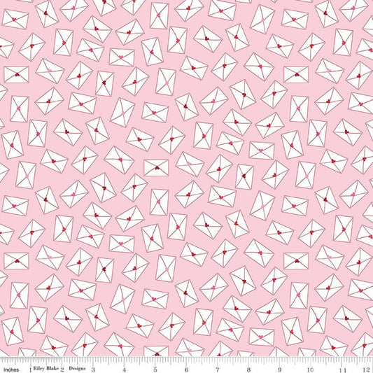 Image of Seasonal Basics Love Notes Pink quilting cotton fabric by Christopher Thompson for Riley Blake Designs. Features envelopes on a pink background. Cute Little Fabric Shop.