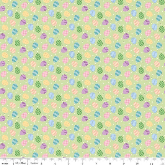 Image of Seasonal Basics Egg Toss Green quilting cotton fabric by Christopher Thompson for Riley Blake Designs. Features eggs on a green background. Cute Little Fabric Shop.