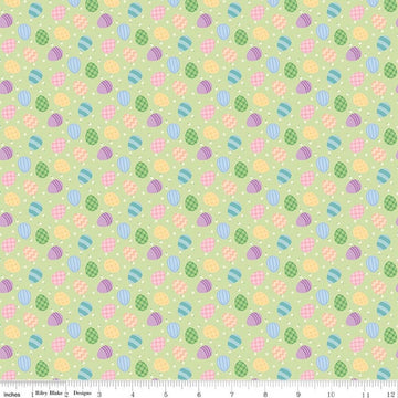 Image of Seasonal Basics Egg Toss Green quilting cotton fabric by Christopher Thompson for Riley Blake Designs. Features eggs on a green background. Cute Little Fabric Shop.
