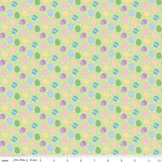 Image of Seasonal Basics Egg Toss Green quilting cotton fabric by Christopher Thompson for Riley Blake Designs. Features eggs on a green background. Cute Little Fabric Shop.