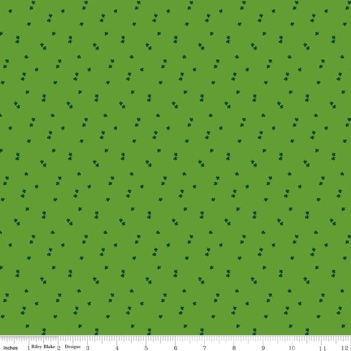 Image of Seasonal Basics Clovers Holly quilting cotton fabric by Christopher Thompson for Riley Blake Designs. Features clovers on a green background. Cute Little Fabric Shop.