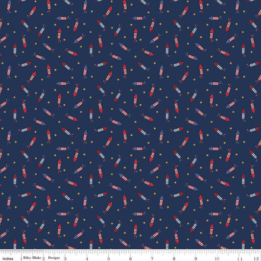 Image of Seasonal Basics Pop Boom Bang Navy quilting cotton fabric by Christopher Thompson for Riley Blake Designs. Features fireworks on a blue background. Cute Little Fabric Shop.