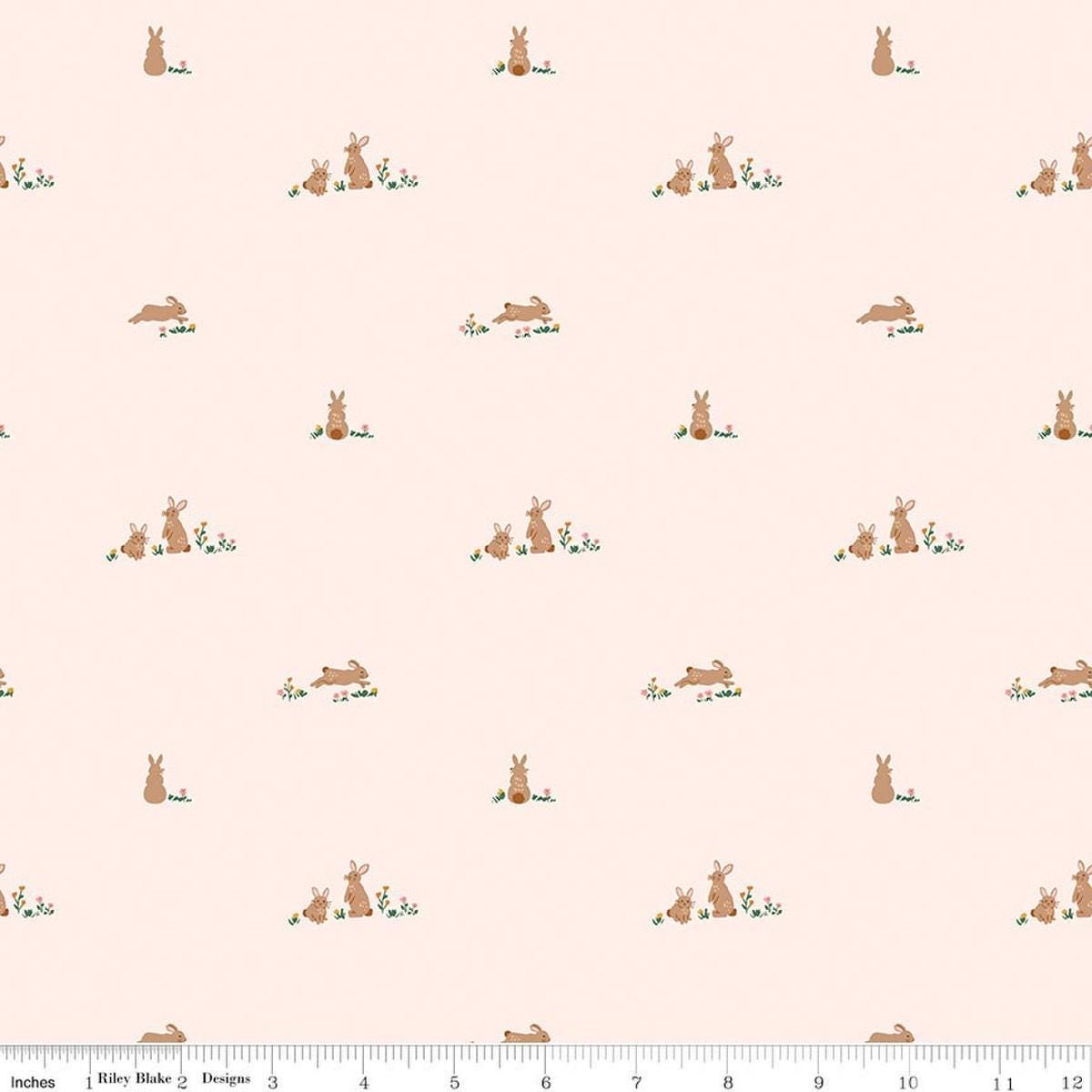 Image of Designer Flannel Sweet Cotton Tales Flopsy Fields Blush quilting cotton fabric by Little Forest Atelier for RIley Blake Designs. Features bunnies on a cream background. Cute Little Fabric Shop.