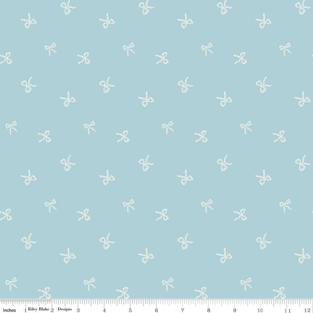 Image of Designer Flannel Sweet Cotton Tales Bows Blue quilting cotton fabric by Little Forest Atelier for RIley Blake Designs. Features bows on a blue background. Cute Little Fabric Shop.