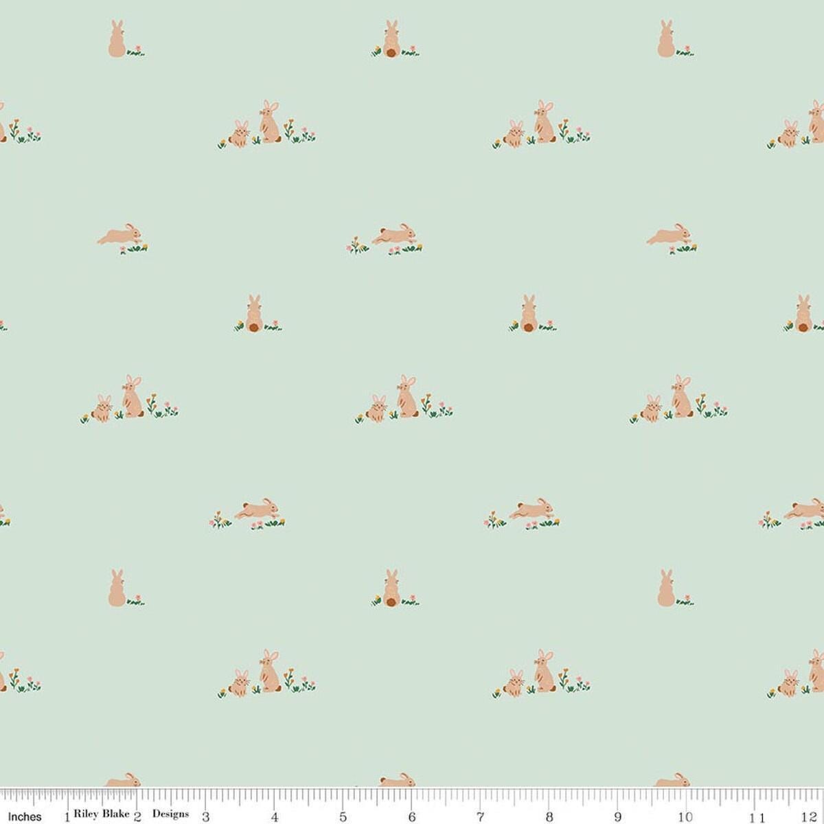Image of Designer Flannel Sweet Cotton Tales Flopsy Fields Mint quilting cotton fabric by Little Forest Atelier for RIley Blake Designs. Features bunnies on a green background. Cute Little Fabric Shop.